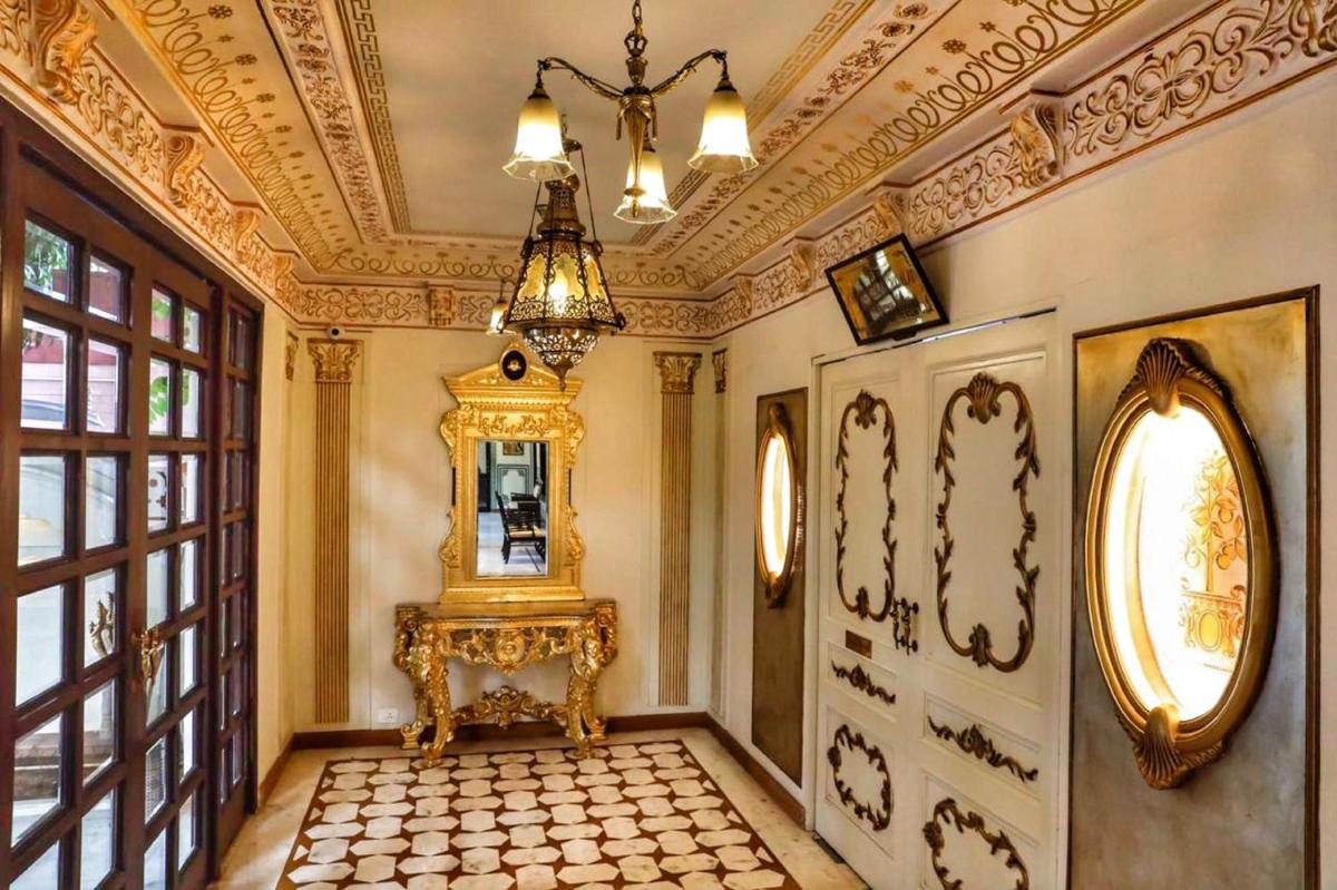 an ornate hallway with a table and a mirror at Shahpura House in Jaipur