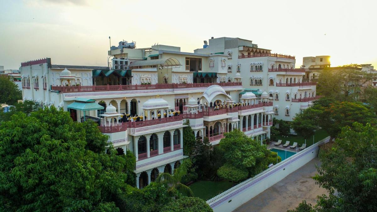 a large white building with trees in front of it at Shahpura House in Jaipur
