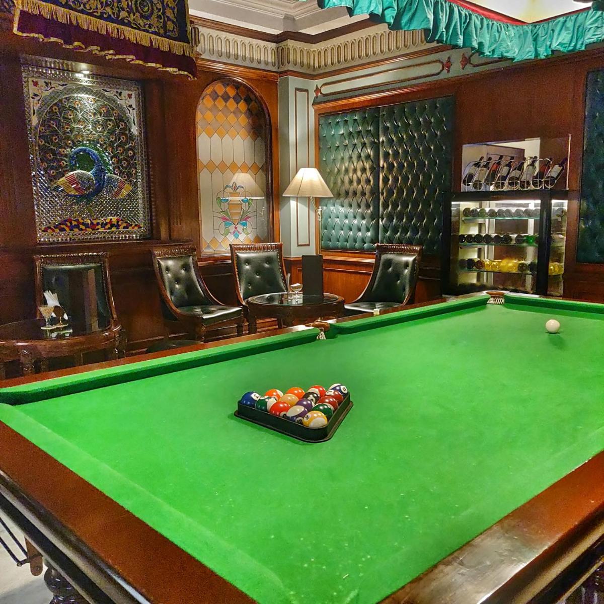 a billiard room with a pool table and chairs at Shahpura House in Jaipur