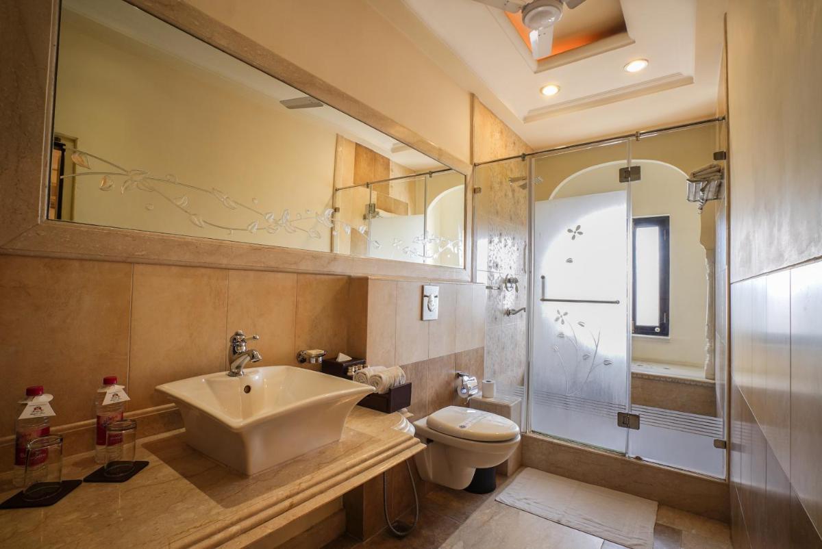 a bathroom with a sink and a toilet at Shahpura House in Jaipur
