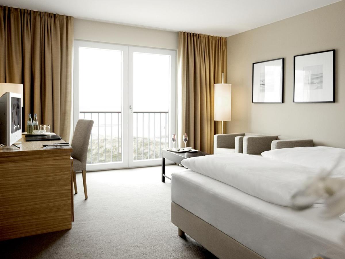Ein Bett oder Betten in einem Zimmer der Unterkunft A-ROSA Sylt
