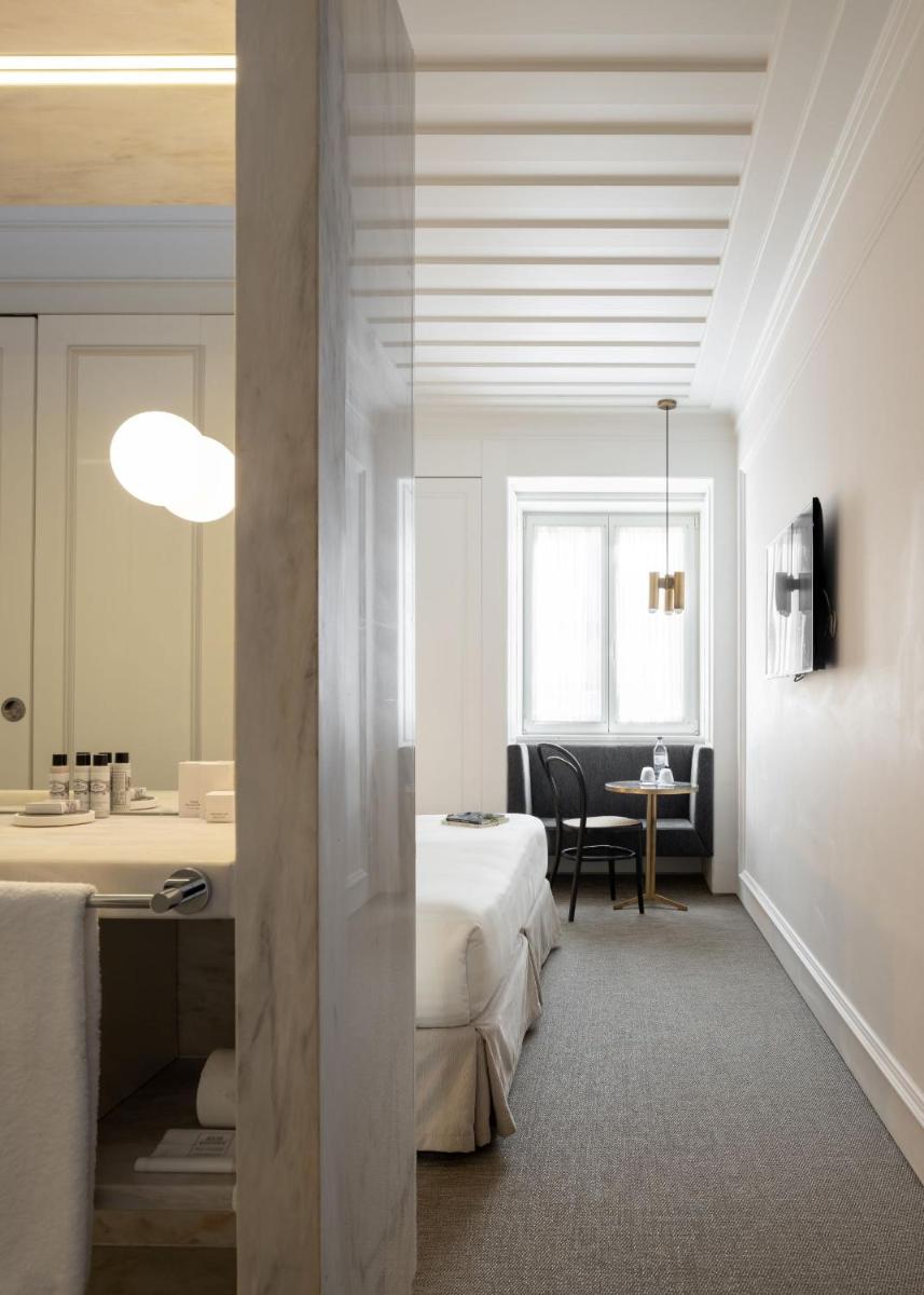 Uma cama ou camas num quarto em Lisboa Pessoa Hotel