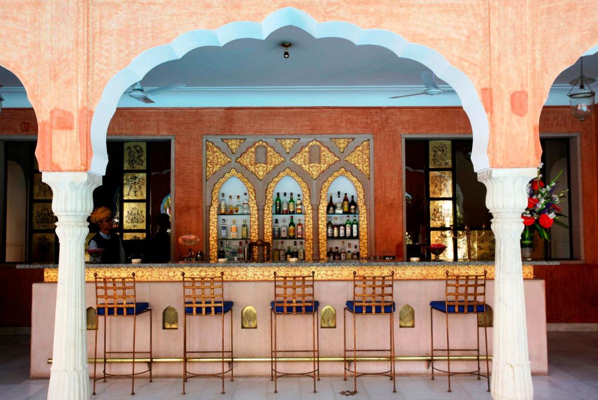 a bar with chairs in front of a building at Samode Haveli in Jaipur