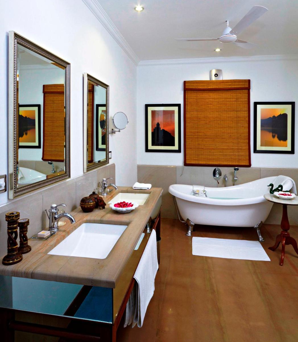 a bathroom with a large tub and a large sink at Samode Haveli in Jaipur