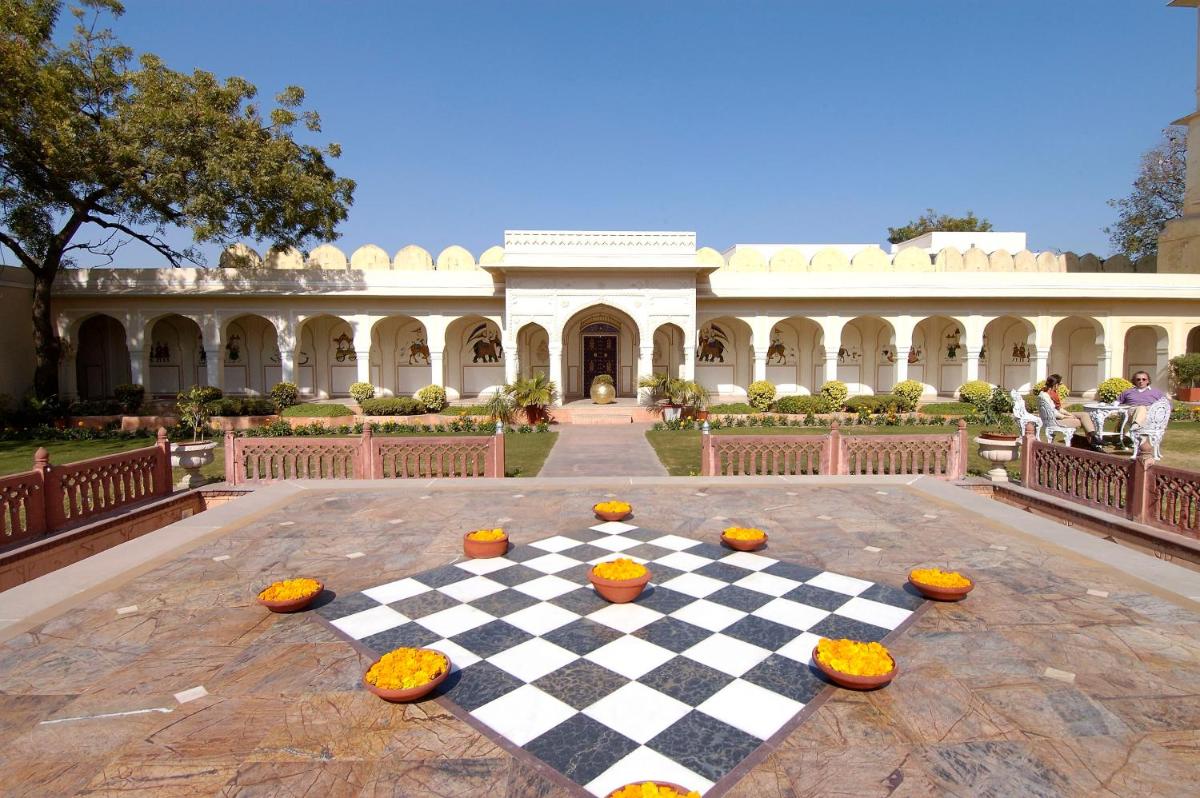a checker board with pumpkins on it in front of a building at The Raj Palace (Small Luxury Hotels of the World) in Jaipur
