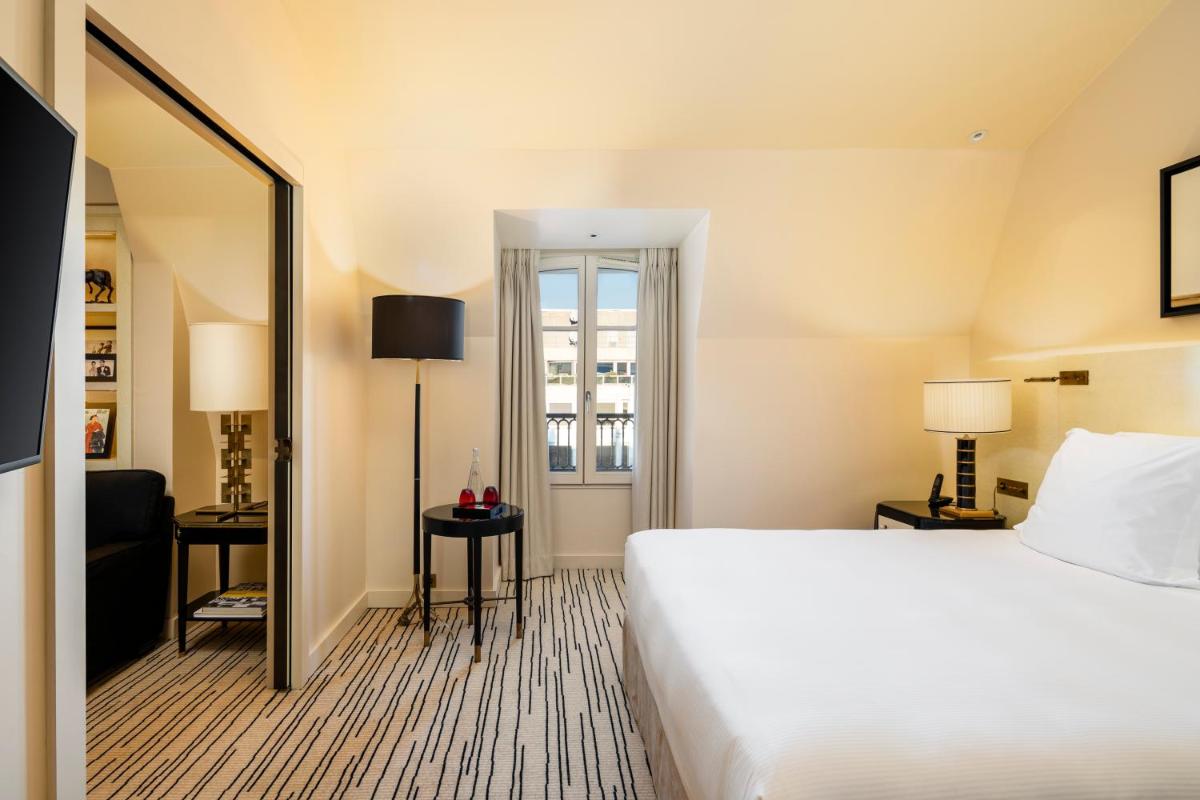 Un ou plusieurs lits dans un hébergement de l'établissement Hotel Montaigne