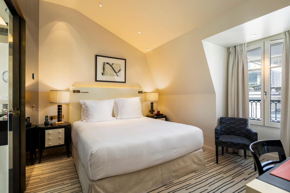 Un ou plusieurs lits dans un hébergement de l'établissement Hotel Montaigne