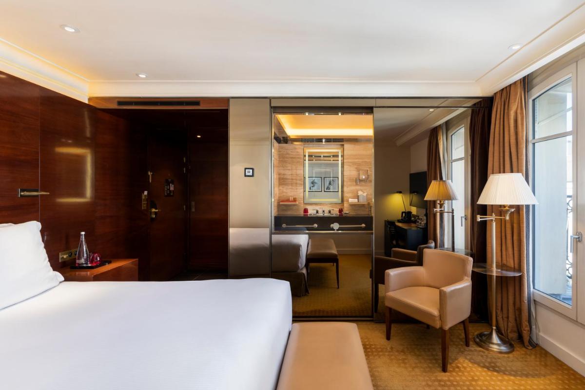 Un ou plusieurs lits dans un hébergement de l'établissement Hotel Montaigne