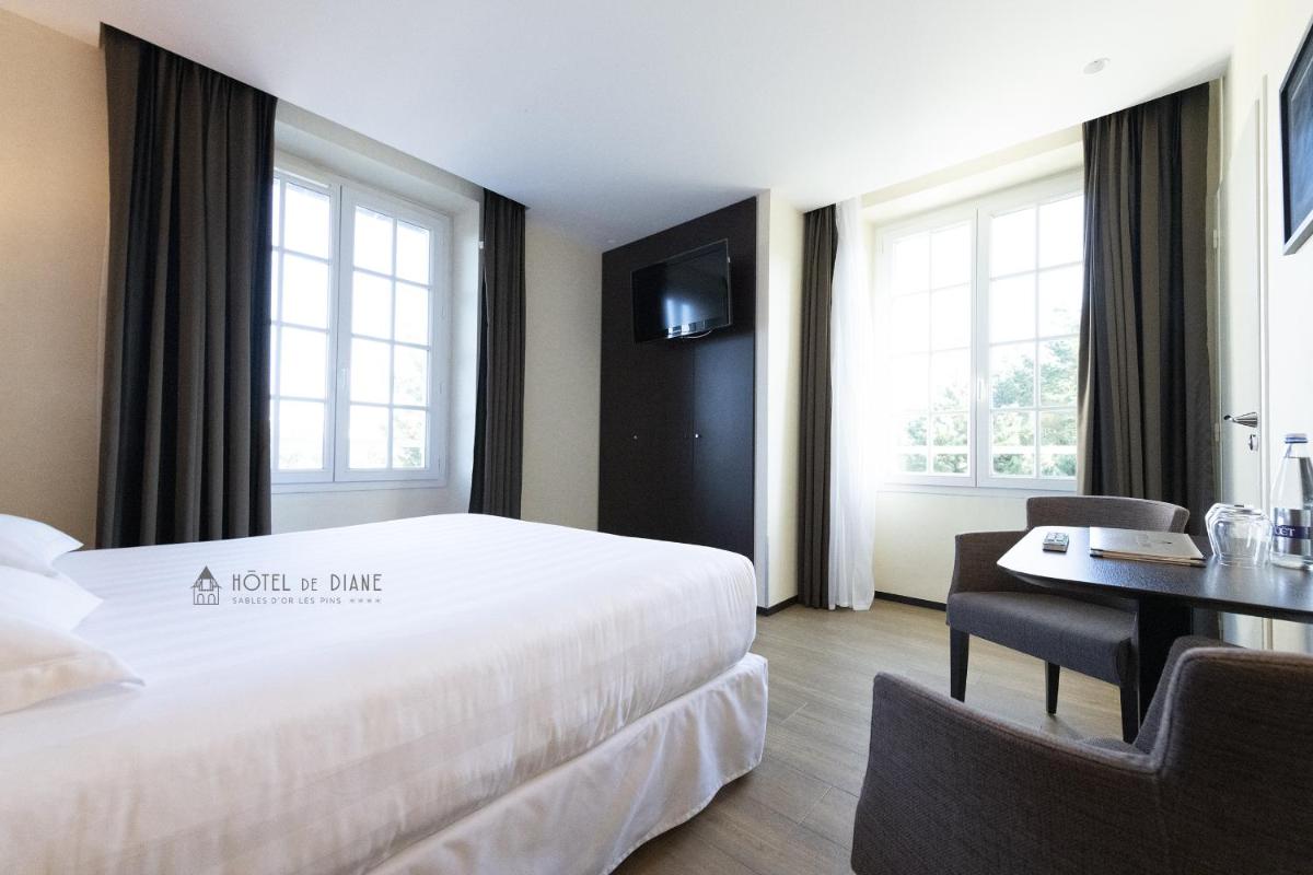 Un ou plusieurs lits dans un hébergement de l'établissement Hotel De Diane
