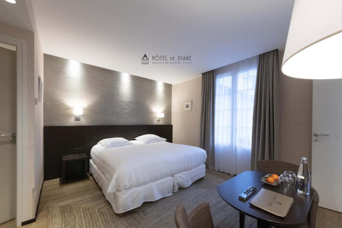 Un ou plusieurs lits dans un hébergement de l'établissement Hotel De Diane