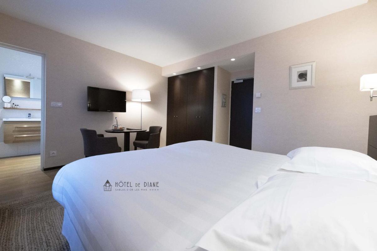 Un ou plusieurs lits dans un hébergement de l'établissement Hotel De Diane
