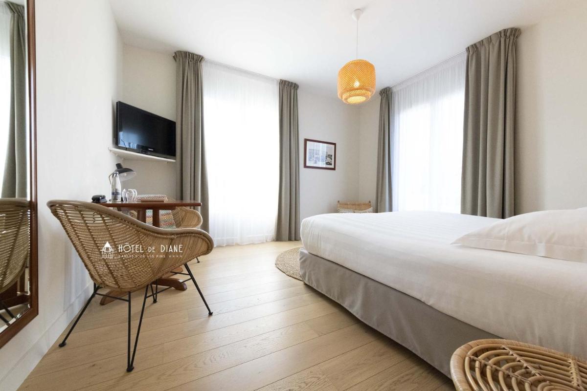 Un ou plusieurs lits dans un hébergement de l'établissement Hotel De Diane