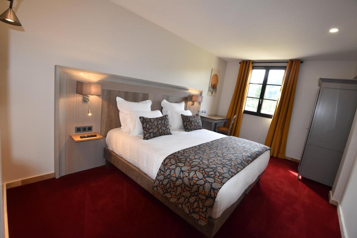 Un ou plusieurs lits dans un hébergement de l'établissement Hotel Le Perigord