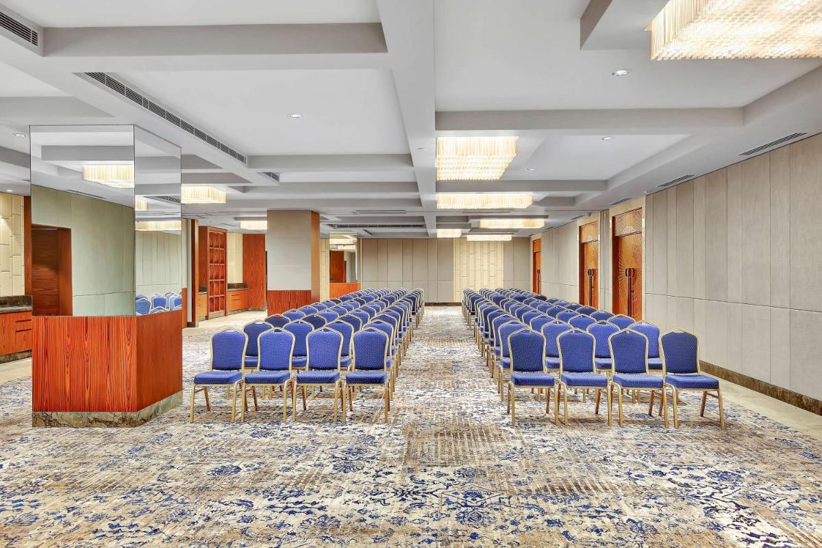 a row of blue chairs in a room at Radisson RED Chandigarh Mohali in Chandīgarh