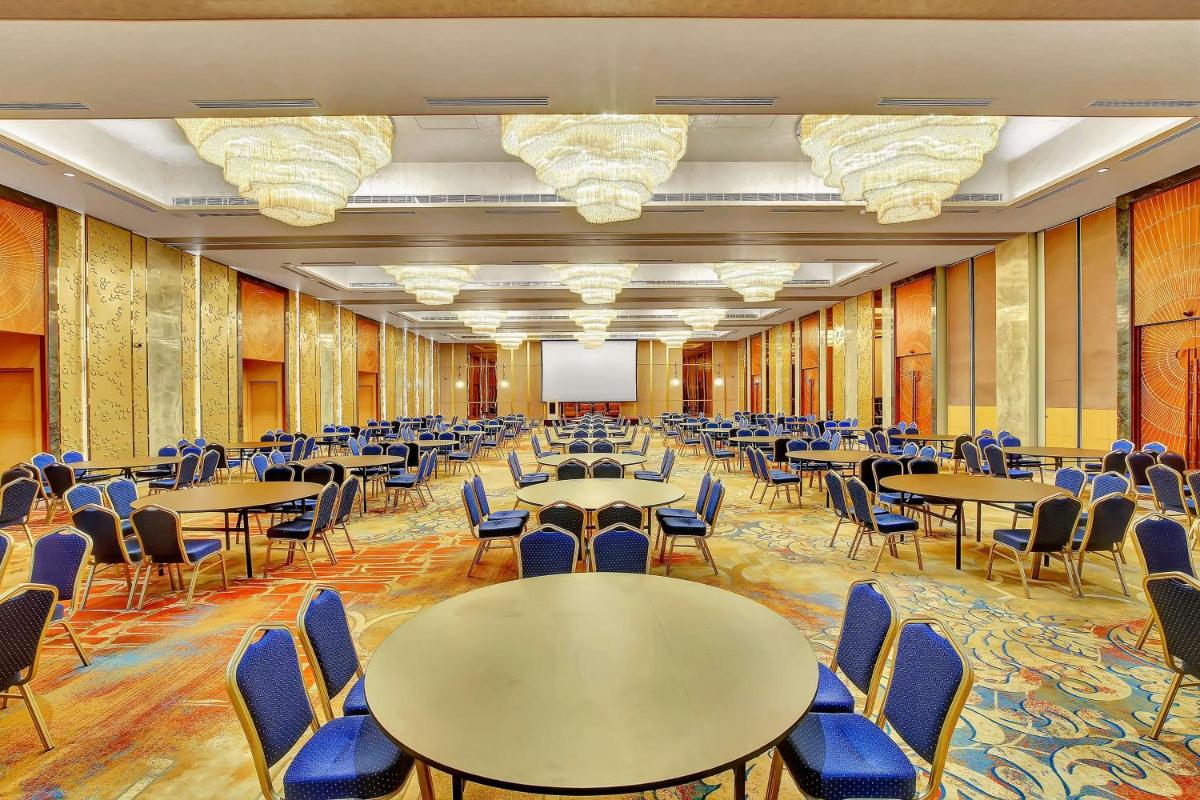 a large room with tables and chairs in it at Radisson RED Chandigarh Mohali in Chandīgarh