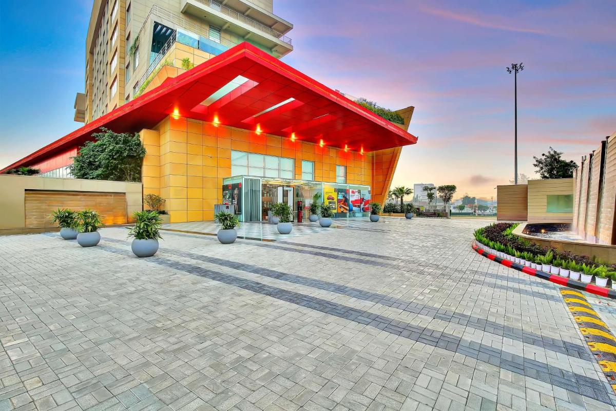 a building with a red roof on a street at Radisson RED Chandigarh Mohali in Chandīgarh