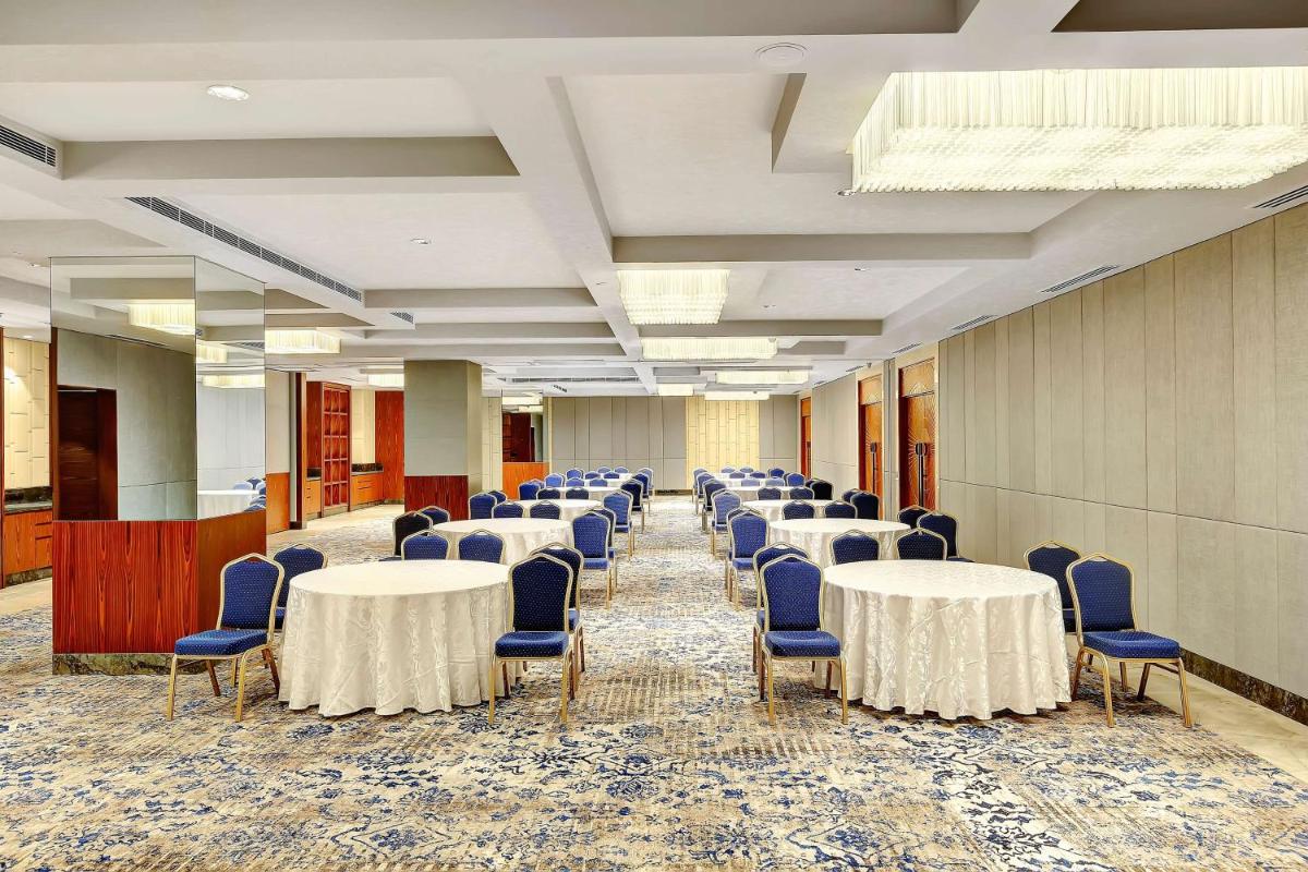 a row of tables and chairs in a room at Radisson RED Chandigarh Mohali in Chandīgarh