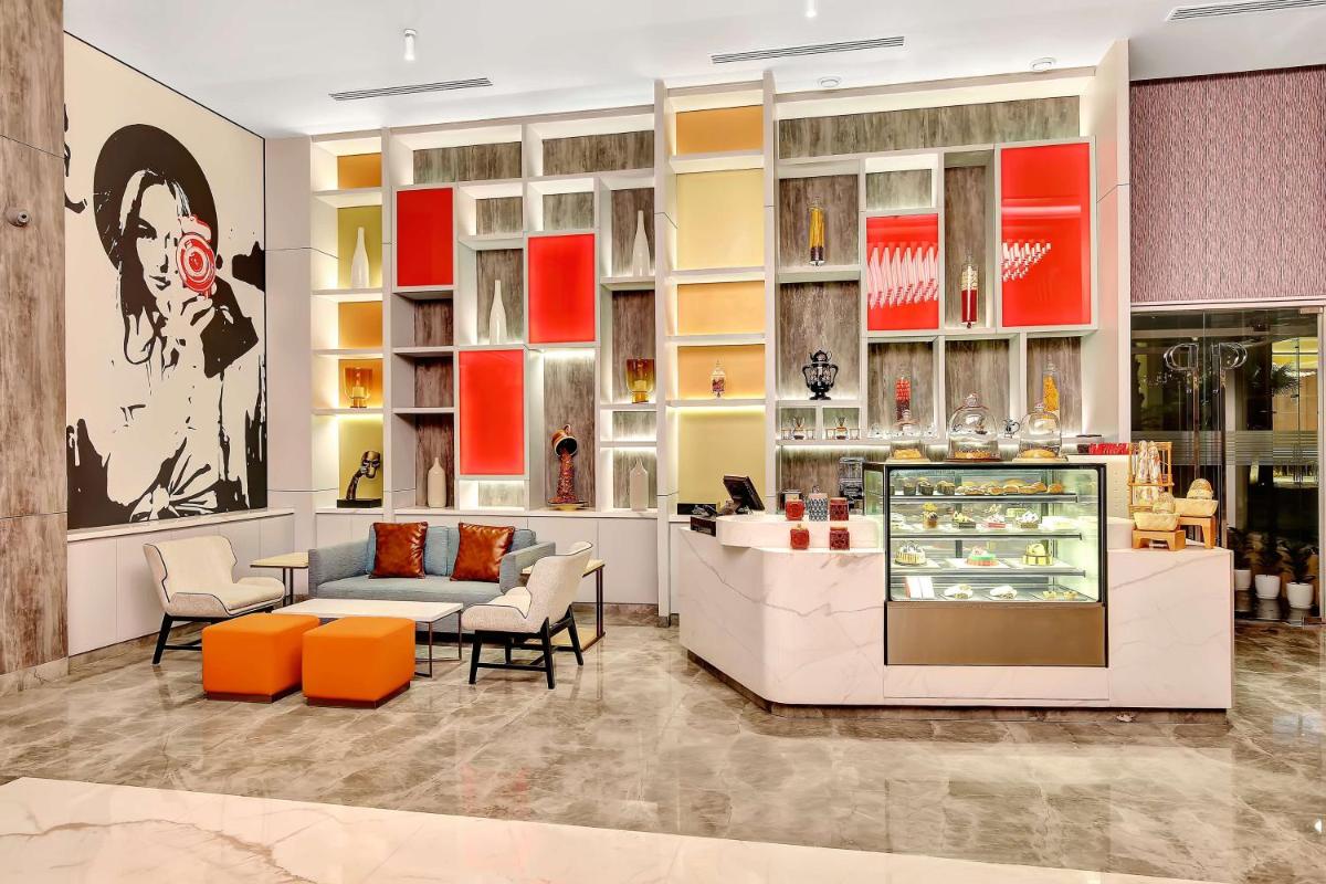 a store with orange and white chairs and a counter at Radisson RED Chandigarh Mohali in Chandīgarh