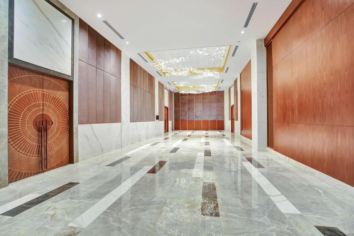an empty hallway with wooden walls and ailed floor at Radisson RED Chandigarh Mohali in Chandīgarh