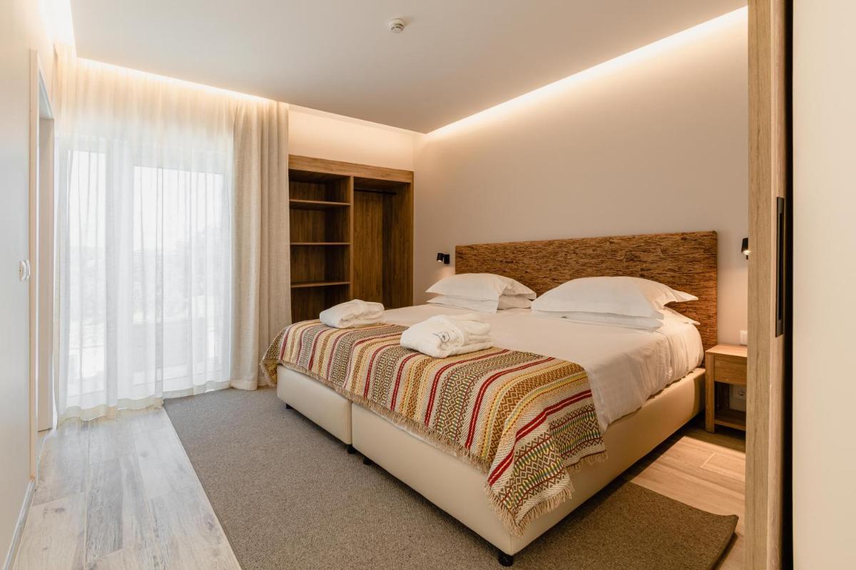 Uma cama ou camas num quarto em Sleep & Nature Hotel