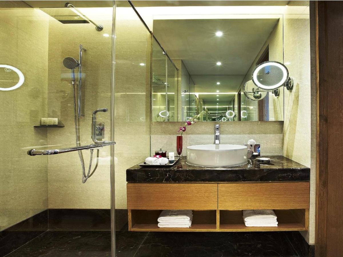 a bathroom with a sink and a shower at Vivanta Chennai IT Expressway OMR in Chennai