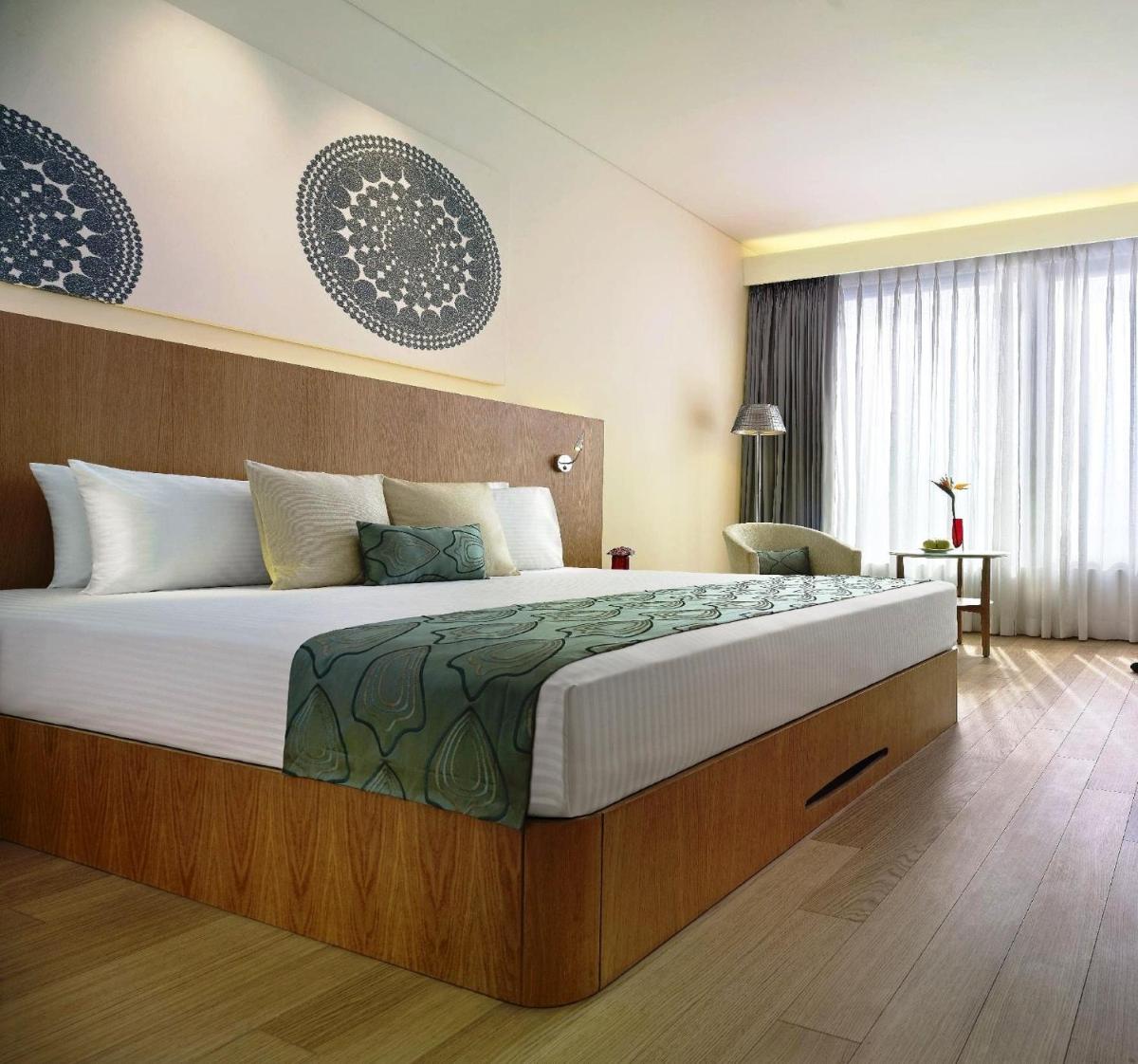 a bedroom with a large bed in a room at Vivanta Chennai IT Expressway OMR in Chennai