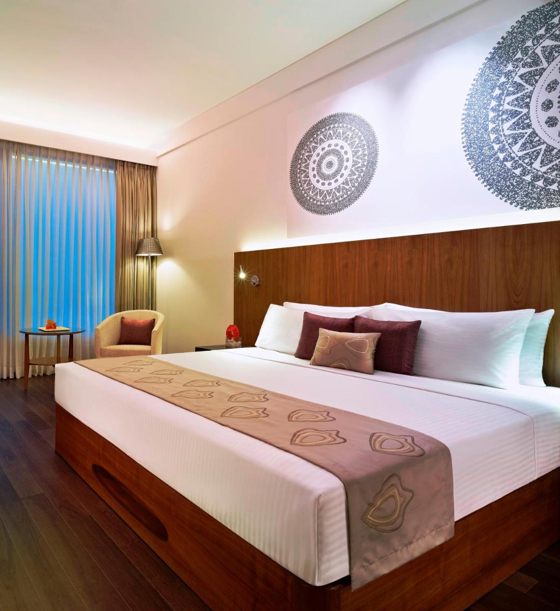 a bedroom with a large bed in a room at Vivanta Chennai IT Expressway OMR in Chennai