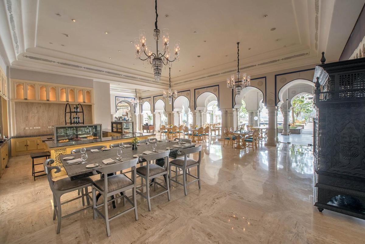 a large dining room with a table and chairs at Fairmont Jaipur in Jaipur