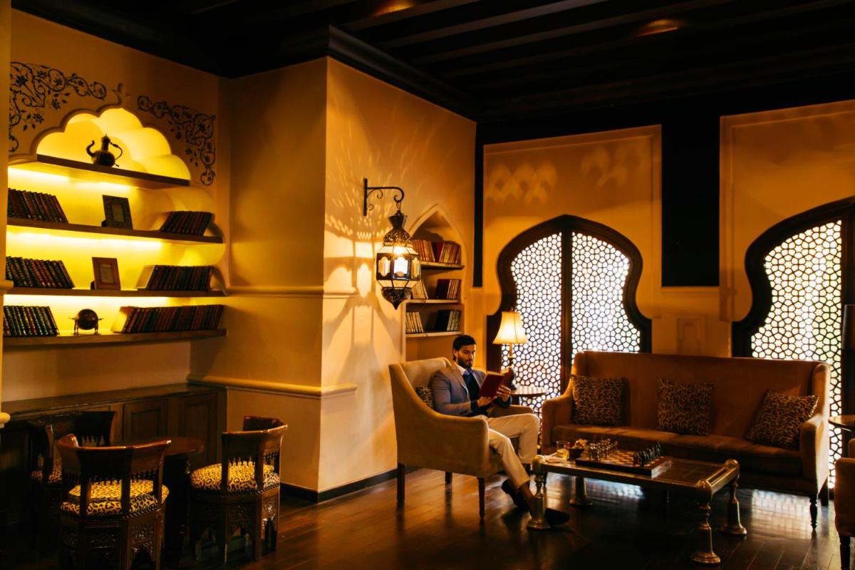 a man sitting in a chair in a living room at Fairmont Jaipur in Jaipur