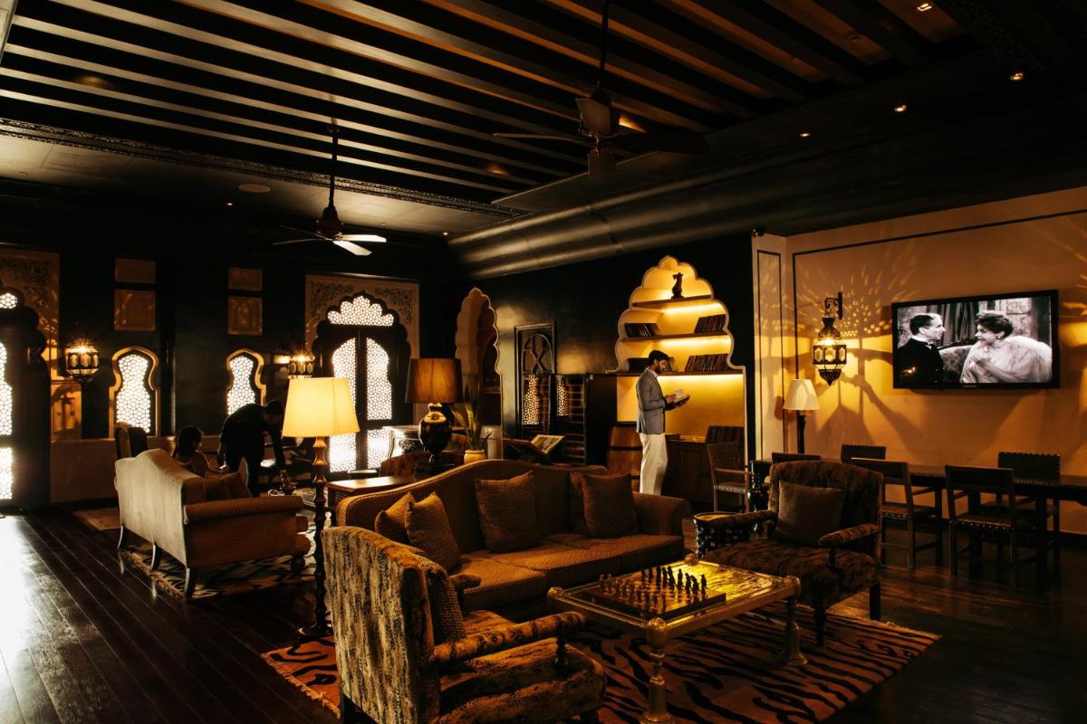 a living room with a couch and chairs and a table at Fairmont Jaipur in Jaipur