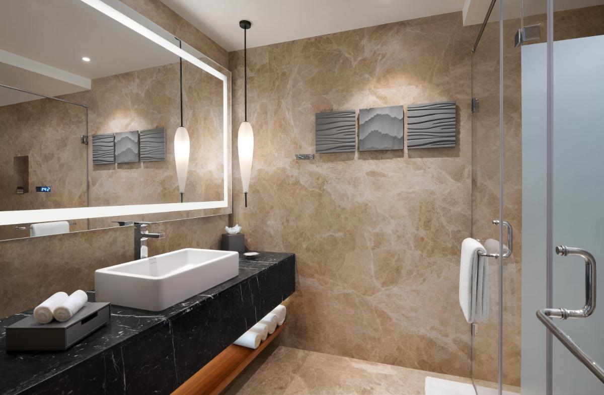 a bathroom with a sink and a mirror at Hyatt Regency Dehradun Resort and Spa in Dehradun