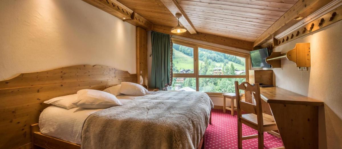 Un ou plusieurs lits dans un hébergement de l'établissement Hotel le Petit Dru