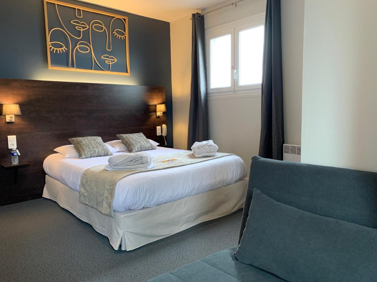 Un ou plusieurs lits dans un hébergement de l'établissement Logis hôtel Aux Berges de l'Aveyron