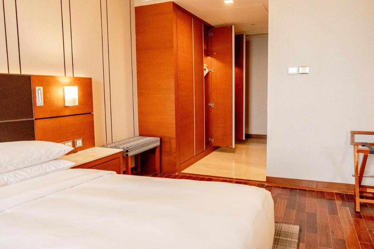 a hotel room with two beds and a hallway at Hyatt Centric Janakpuri New Delhi in New Delhi
