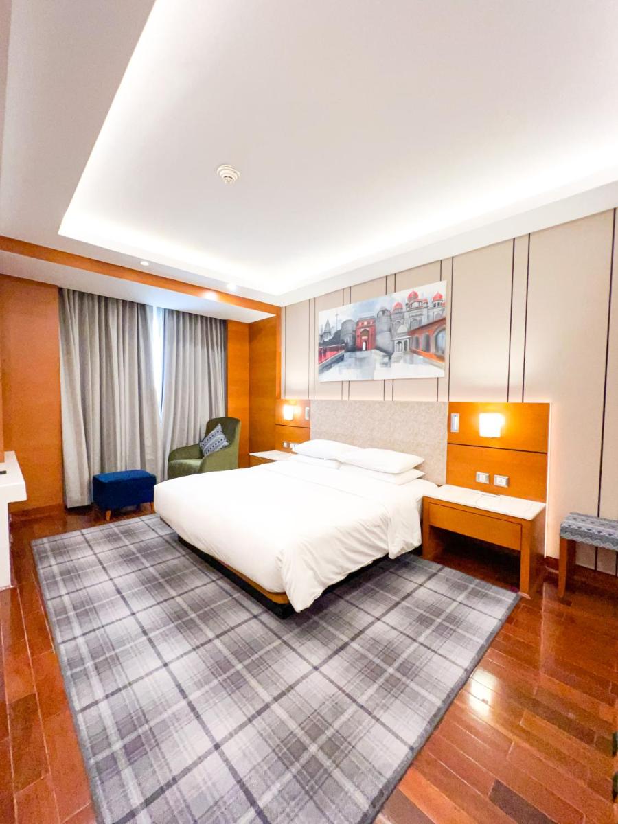 a bedroom with a large white bed in it at Hyatt Centric Janakpuri New Delhi in New Delhi