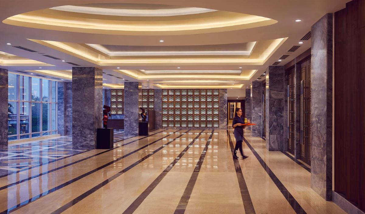 a man standing in a hallway in a building at Hyatt Centric Janakpuri New Delhi in New Delhi