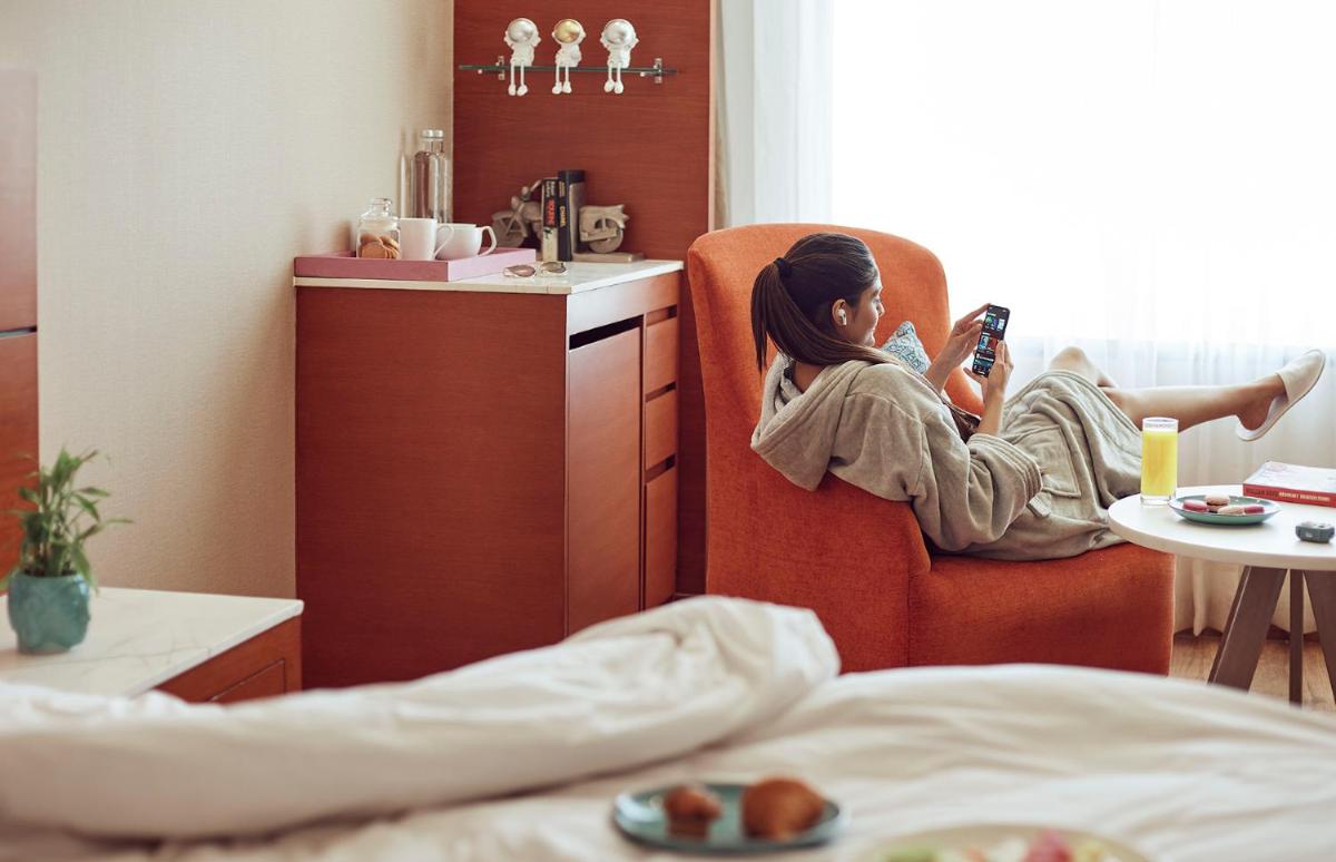 a girl laying on a chair taking a picture of a room at Hyatt Centric Janakpuri New Delhi in New Delhi