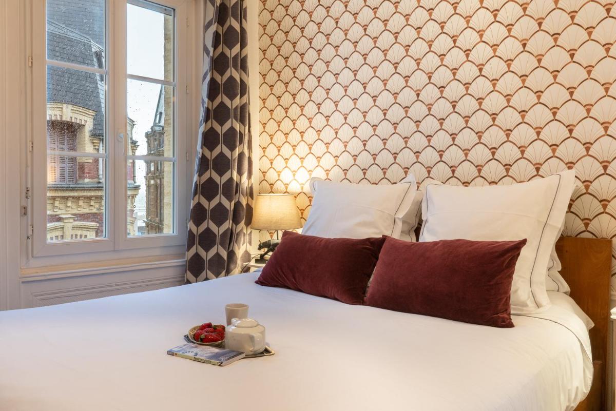 une chambre avec un lit blanc avec une fenêtre dans l'établissement TOWNHOUSE TROUVILLE - Appart'Hotel & Studios, à Trouville-sur-Mer