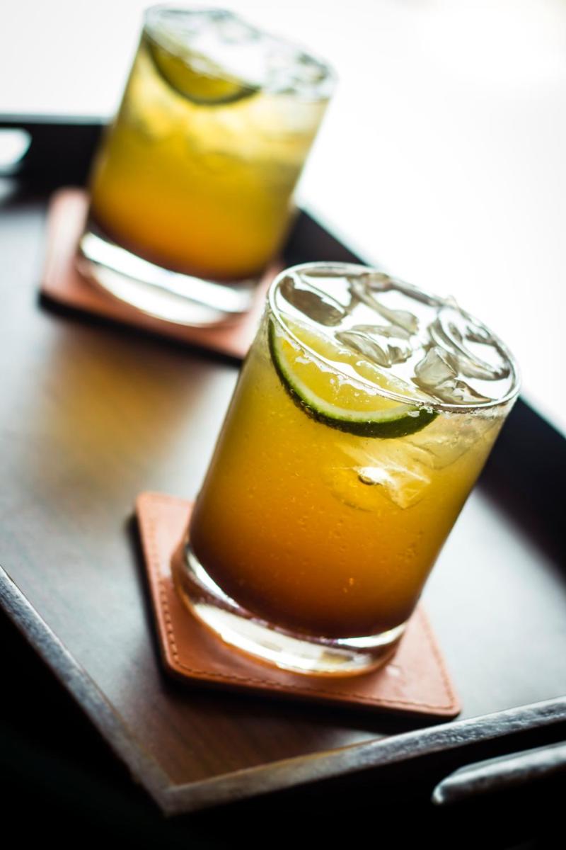 two glasses of orange juice with a slice of lime at The Anya Hotel-Golf Course Road in Gurgaon