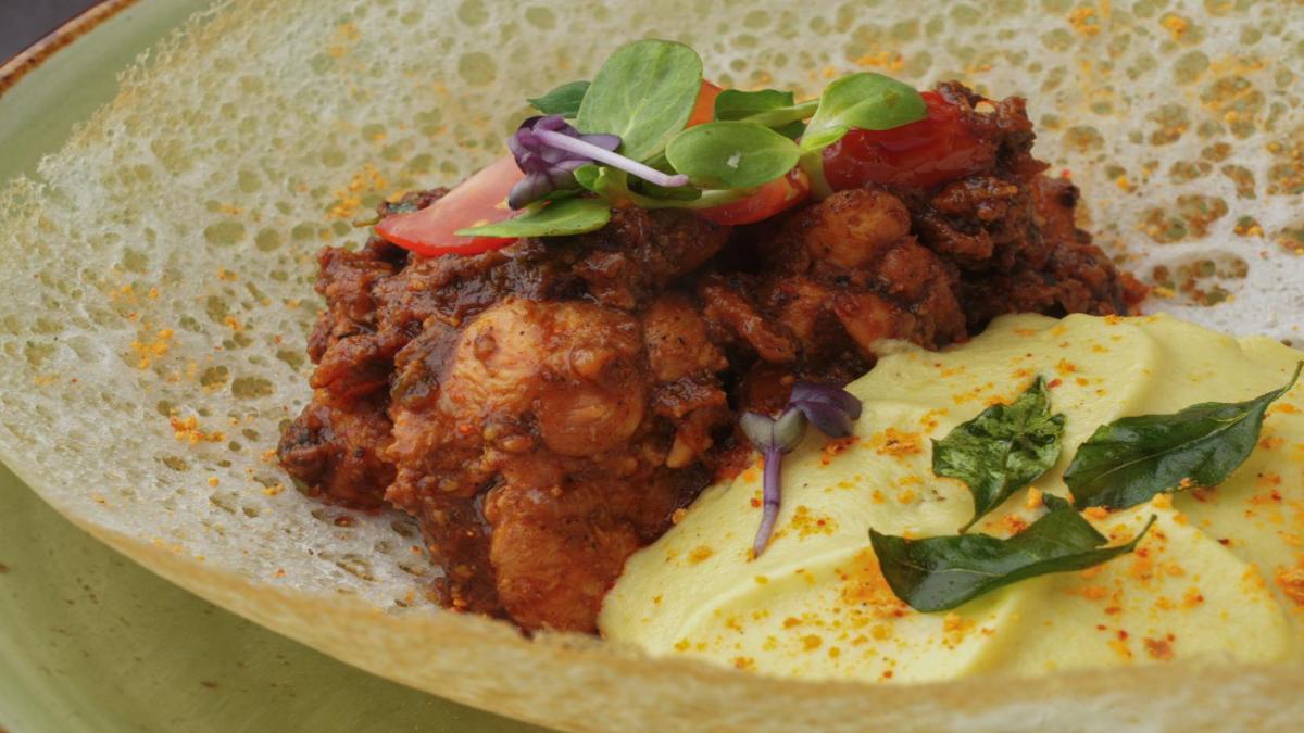 a plate of food with meat and eggs on it at Holiday Inn Bengaluru Racecourse by IHG in Bengaluru a plate of food with meat and eggs on it at Holiday Inn Bengaluru Racecourse by IHG in Bengaluru