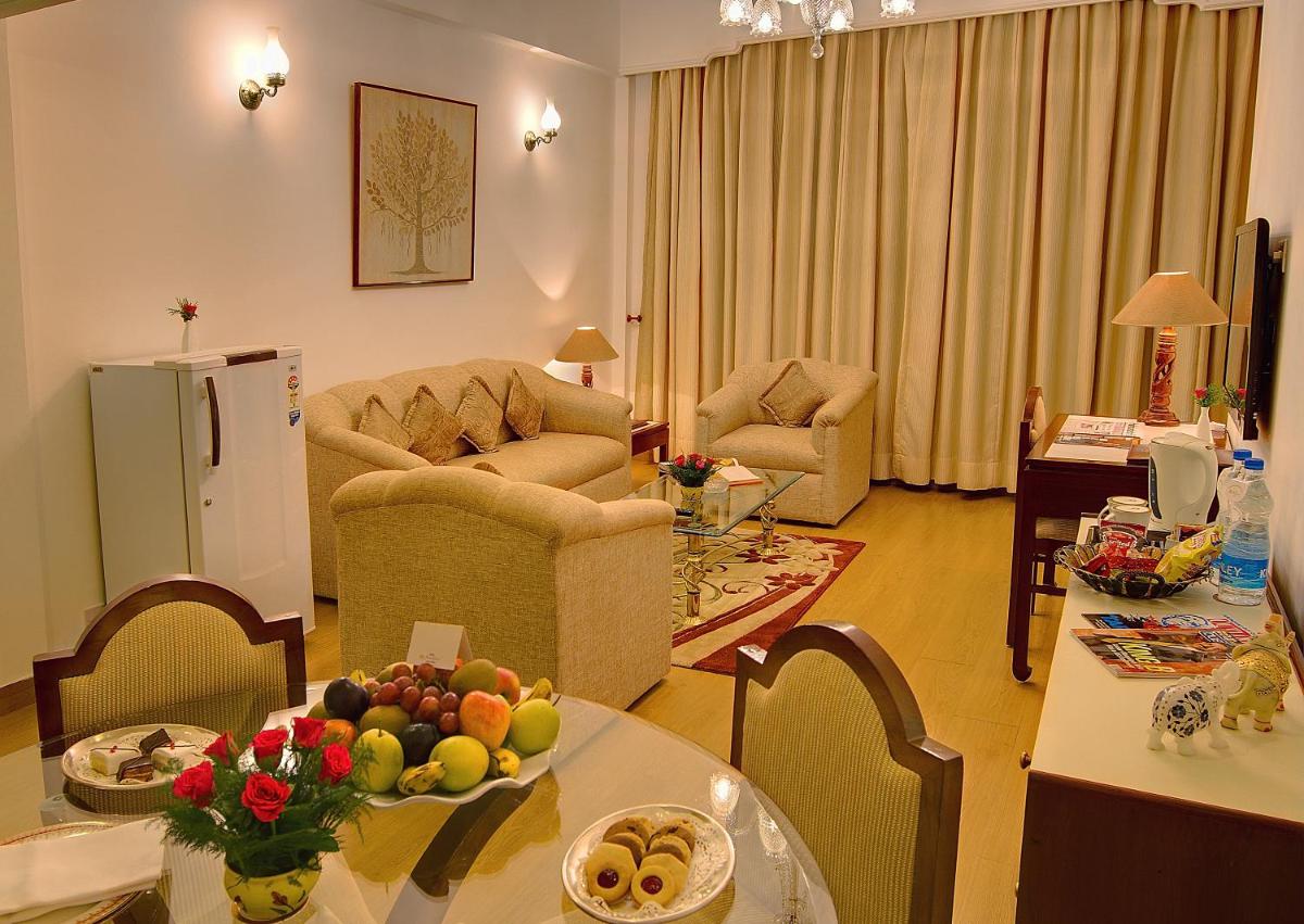 a living room with a table with fruit on it at Hotel Clarks Shiraz in Agra