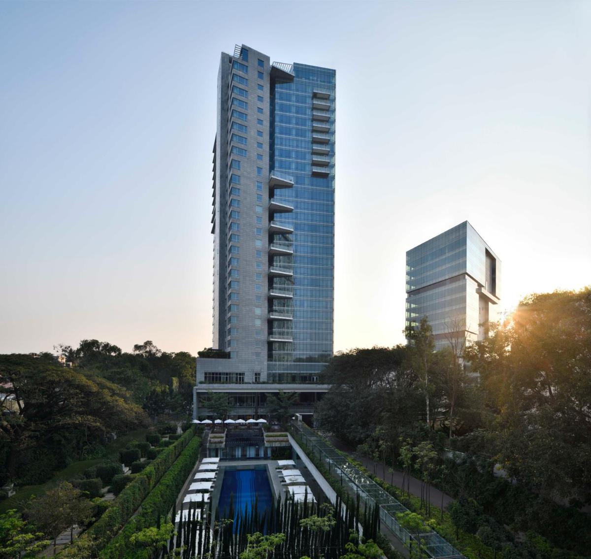 a tall building with a river in front of it at Four Seasons Hotel Bengaluru at Embassy ONE in Bengaluru a tall building with a river in front of it at Four Seasons Hotel Bengaluru at Embassy ONE in Bengaluru