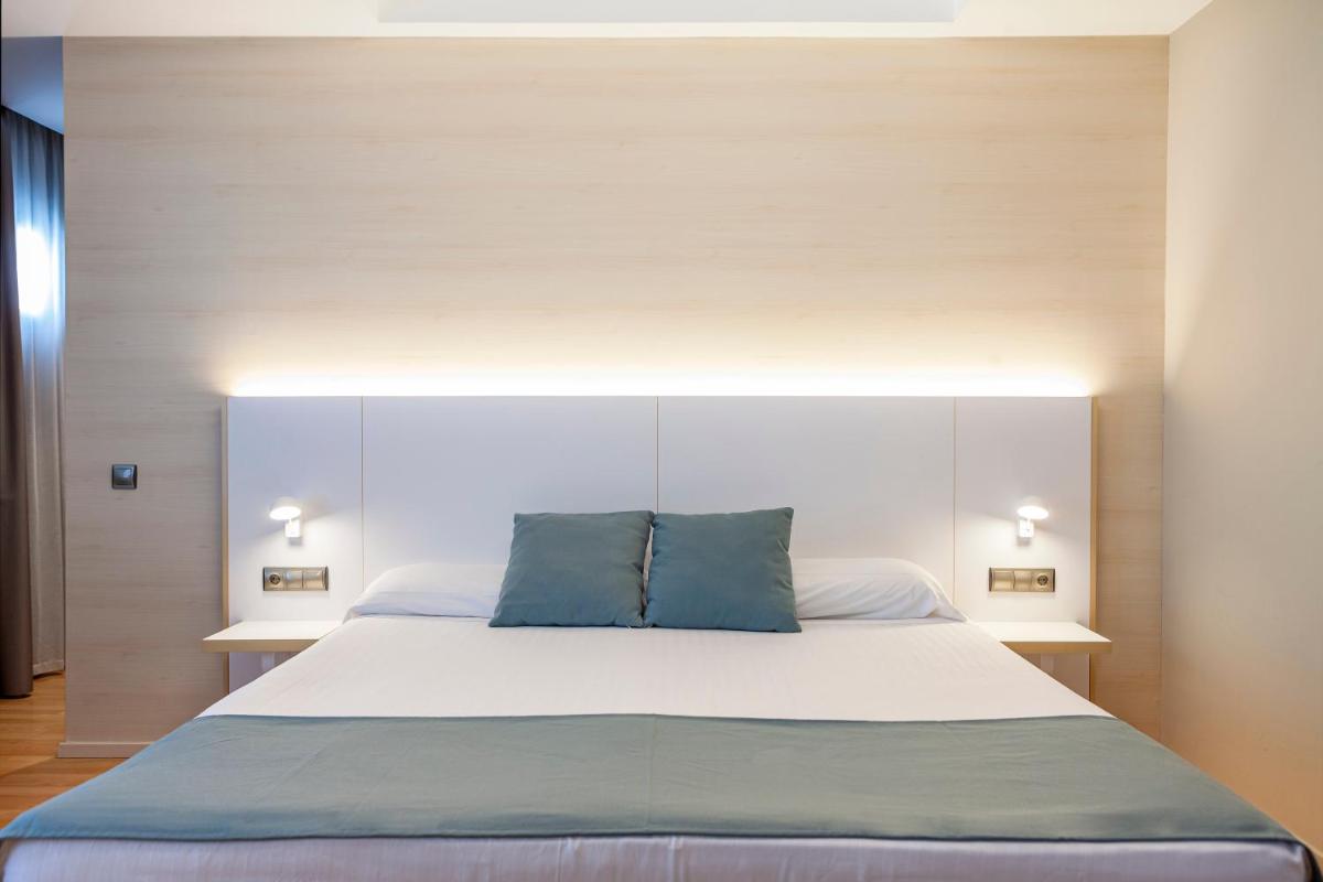 Cama o camas de una habitación en Hotel Olympia Valencia