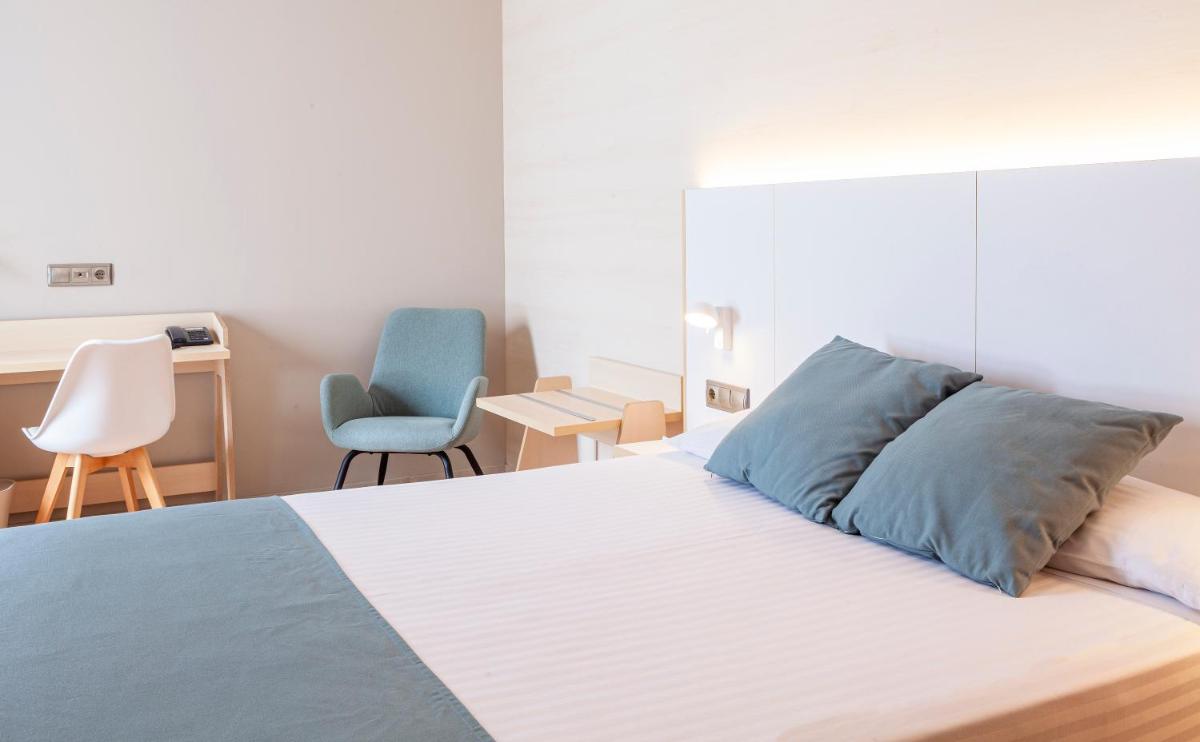 Cama o camas de una habitación en Hotel Olympia Valencia