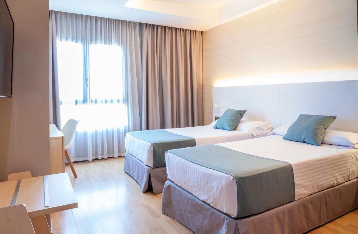 Cama o camas de una habitación en Hotel Olympia Valencia