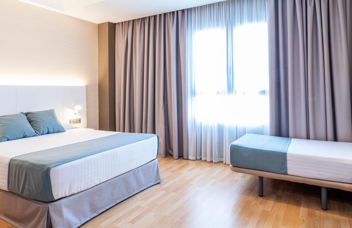 Cama o camas de una habitación en Hotel Olympia Valencia