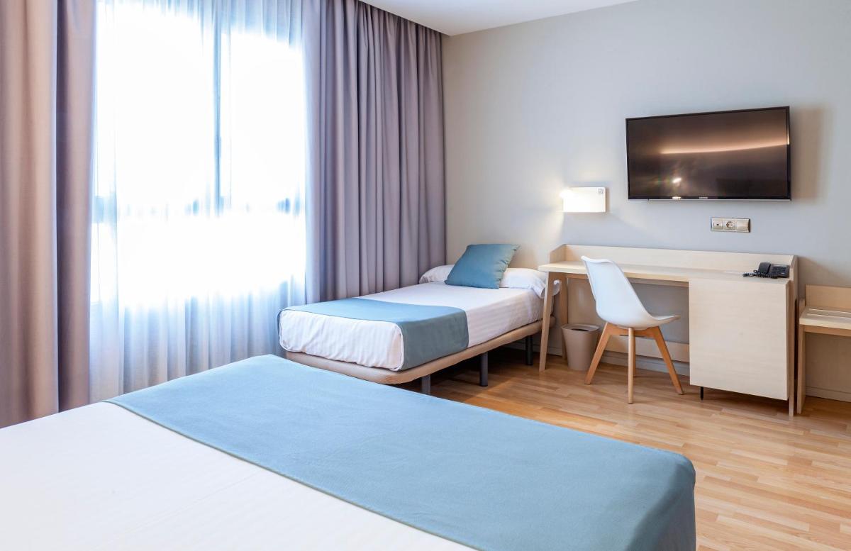Cama o camas de una habitación en Hotel Olympia Valencia