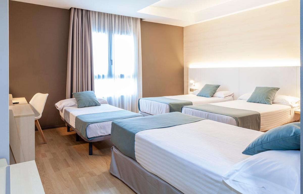Cama o camas de una habitación en Hotel Olympia Valencia