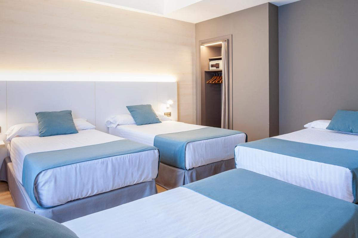 Cama o camas de una habitación en Hotel Olympia Valencia