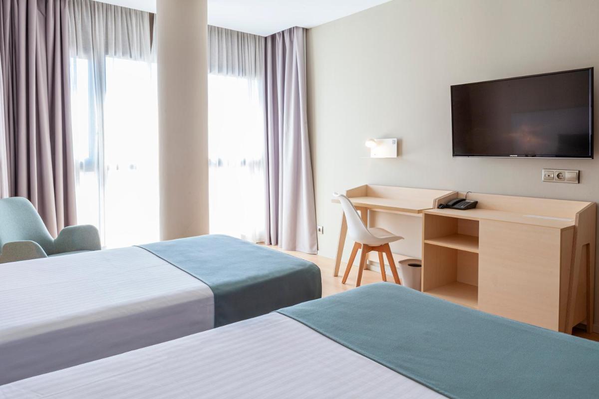 Cama o camas de una habitación en Hotel Olympia Valencia